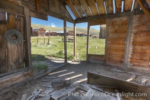 Old barn, interior with Main Street buildings in background, Bodie State Historical Park, California