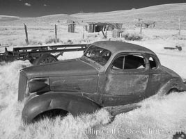 Old car lying in dirt field, Bodie State Historical Park, California