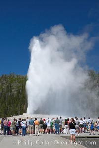 A crowd enjoys watching Old Faithful geyser at peak eruption, Upper Geyser Basin, Yellowstone National Park, Wyoming