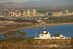 Old Point Loma Lighthouse, sitting high atop the end of Point Loma peninsula, seen here with San Diego Bay and downtown San Diego in the distance.  The old Point Loma lighthouse operated from 1855 to 1891 above the entrance to San Diego Bay. It is now a maintained by the National Park Service and is part of Cabrillo National Monument