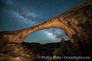 Owachomo Bridge and Milky Way.  Owachomo Bridge, a natural stone bridge standing 106' high and spanning 130' wide,stretches across a canyon with the Milky Way crossing the night sky, Natural Bridges National Monument, Utah