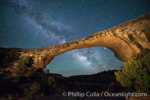 Owachomo Bridge and Milky Way.  Owachomo Bridge, a natural stone bridge standing 106' high and spanning 130' wide,stretches across a canyon with the Milky Way crossing the night sky, Natural Bridges National Monument, Utah