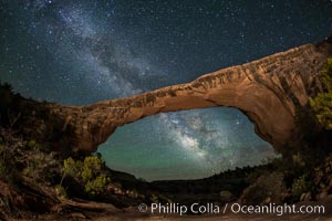 Owachomo Bridge and Milky Way.  Owachomo Bridge, a natural stone bridge standing 106' high and spanning 130' wide,stretches across a canyon with the Milky Way crossing the night sky, Natural Bridges National Monument, Utah