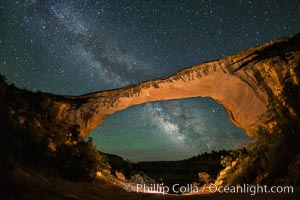 Owachomo Bridge and Milky Way.  Owachomo Bridge, a natural stone bridge standing 106' high and spanning 130' wide,stretches across a canyon with the Milky Way crossing the night sky, Natural Bridges National Monument, Utah