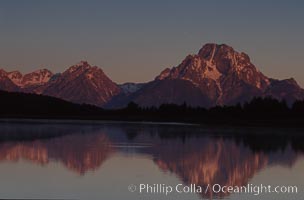 Mount Moran in the Teton Range is reflected at sunrise in a sidewater of the Snake River at Oxbow Bend, summer, Grand Teton National Park, Wyoming