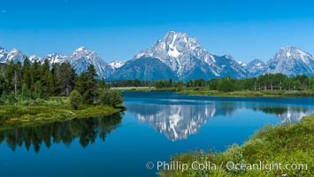 Mount Moran in the Teton Range is reflected in a sidewater of the Snake River at Oxbow Bend, summer, Grand Teton National Park, Wyoming