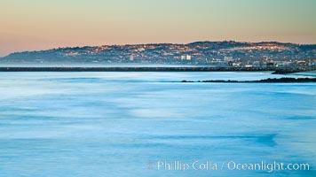 Pacific Beach and La Jolla and Mount Soledad at dawn, viewed over breaking waves from the Ocean Beach Pier