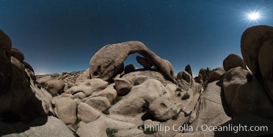 Panoramic image of Arch Rock lit by a full moon.