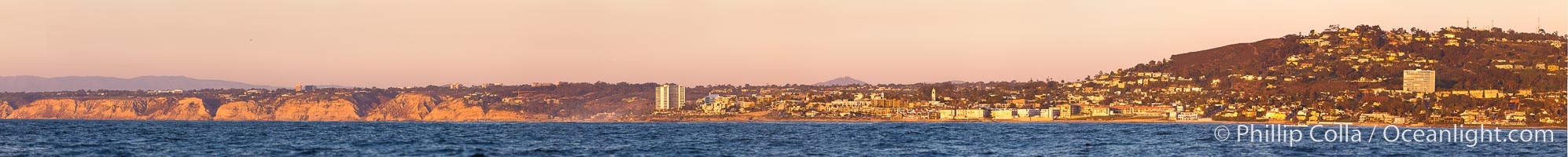 Panorama of La Jolla, with Mount Soledad aglow at sunset, viewed from the Pacific Ocean offshore of San Diego