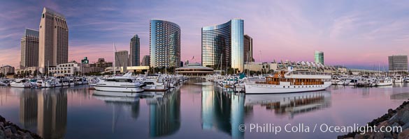 Panoramic photo of San Diego embarcadero, showing the San Diego Marriott Hotel and Marina (center), Roy's Restaurant (center) and Manchester Grand Hyatt Hotel (left) viewed from the San Diego Embacadero Marine Park.