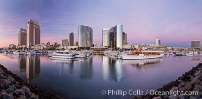 Panoramic photo of San Diego embarcadero, showing the San Diego Marriott Hotel and Marina (center), Roy's Restaurant (center) and Manchester Grand Hyatt Hotel (left) viewed from the San Diego Embarcadero Marine Park