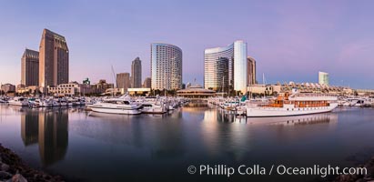 Panoramic photo of San Diego embarcadero, showing the San Diego Marriott Hotel and Marina (center), Roy's Restaurant (center) and Manchester Grand Hyatt Hotel (left) viewed from the San Diego Embarcadero Marine Park