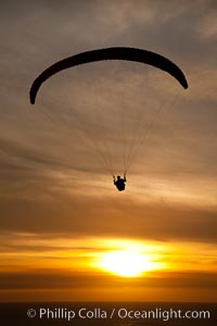 Paraglider soaring at Torrey Pines Gliderport, sunset, flying over the Pacific Ocean, La Jolla, California