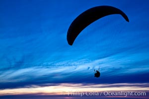 Paraglider soaring at Torrey Pines Gliderport, sunset, flying over the Pacific Ocean, La Jolla, California