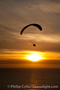 Paraglider soaring at Torrey Pines Gliderport, sunset, flying over the Pacific Ocean, La Jolla, California