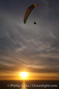 Paraglider soaring at Torrey Pines Gliderport, sunset, flying over the Pacific Ocean, La Jolla, California