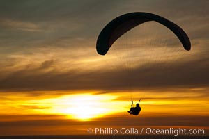 Paraglider soaring at Torrey Pines Gliderport, sunset, flying over the Pacific Ocean, La Jolla, California