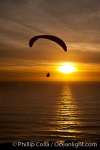 Paraglider soaring at Torrey Pines Gliderport, sunset, flying over the Pacific Ocean, La Jolla, California