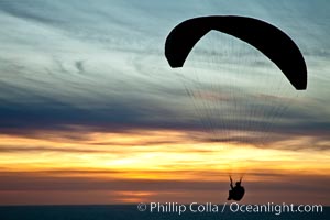 Paraglider soaring at Torrey Pines Gliderport, sunset, flying over the Pacific Ocean, La Jolla, California