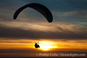 Paraglider soaring at Torrey Pines Gliderport, sunset, flying over the Pacific Ocean, La Jolla, California