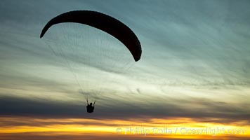 Paraglider soaring at Torrey Pines Gliderport, sunset, flying over the Pacific Ocean, La Jolla, California