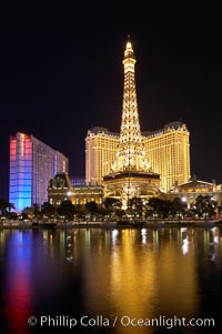 The Bellagio Hotel fountains light up the reflection pool as the half-scale replica of the Eiffel Tower at the Paris Hotel in Las Vegas rises above them, at night