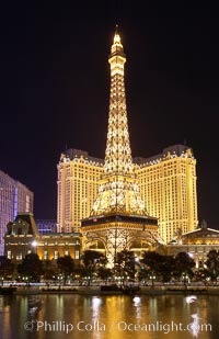 The half-scale replica of the Eiffel Tower at the Paris Hotel in Las Vegas is reflected in the Bellagio Hotel fountain pool at night