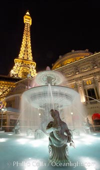 The half-scale replica of the Eiffel Tower rises above a fountain at night, Paris Hotel, Las Vegas, Nevada