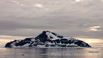 Paulet Island, near the Antarctic Peninsula, is a cinder cone flanks by lava flows on which thousands of Adelie Penguins nest