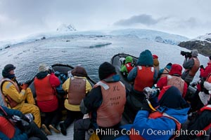 Photographers enjoy a crabeater seal, from two inflatable zodiacs in Cierva Cove