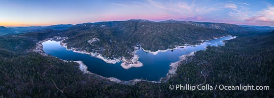 Spectacular pink sunset over Bass Lake viewed from the top of Goat Mountain, aerial panoramic photo