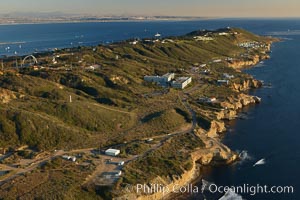 Point Loma peninsula, with scalloped sandstone cliffs edging the Pacific Ocean, looking south.   Navy facilities are scattered along this section of Point Loma.