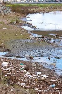 Pollution accumulates in the Tijuana River Valley following winter storms which flush the trash from Tijuana in Mexico across the border into the United States, Imperial Beach, San Diego, California