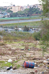 Pollution accumulates in the Tijuana River Valley following winter storms which flush the trash from Tijuana in Mexico across the border into the United States, Imperial Beach, San Diego, California