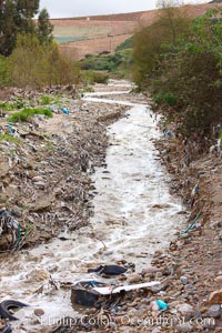 Pollution accumulates in the Tijuana River Valley following winter storms which flush the trash from Tijuana in Mexico across the border into the United States, Imperial Beach, San Diego, California