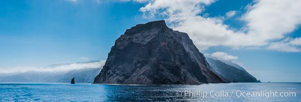 Punta Norte, the northern point of Guadalupe Island, viewed from the north.  Punta Desfiladero (Blunt Point) and Roca Elefante are just visible at far right, and Roca Piloto (Pilot Rock) is see to the left of the island against the distant sweep of the cliffs that comprise the northeastern bight of the island, actually the rim of an enormous caldera, Guadalupe Island (Isla Guadalupe)