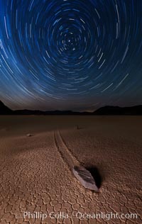 Racetrack sailing stone and star trails.  A sliding rock of the Racetrack Playa. The sliding rocks, or sailing stones, move across the mud flats of the Racetrack Playa, leaving trails behind in the mud. The explanation for their movement is not known with certainty, but many believe wind pushes the rocks over wet and perhaps icy mud in winter