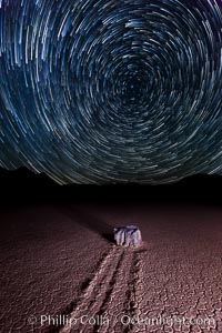 Racetrack sailing stone and star trails.  A sliding rock of the Racetrack Playa. The sliding rocks, or sailing stones, move across the mud flats of the Racetrack Playa, leaving trails behind in the mud. The explanation for their movement is not known with certainty, but many believe wind pushes the rocks over wet and perhaps icy mud in winter