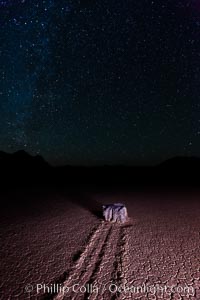 Racetrack sailing stone and stars at night. A sliding rock of the Racetrack Playa. The sliding rocks, or sailing stones, move across the mud flats of the Racetrack Playa, leaving trails behind in the mud. The explanation for their movement is not known with certainty, but many believe wind pushes the rocks over wet and perhaps icy mud in winter, Death Valley National Park, California