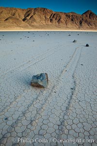 Sailing stone on the Death Valley Racetrack playa.  The sliding rocks, or sailing stones, move across the mud flats of the Racetrack Playa, leaving trails behind in the mud.  The explanation for their movement is not known with certainty, but many believe wind pushes the rocks over wet and perhaps icy mud in winter, Death Valley National Park, California