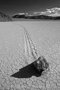 Sailing stone on the Death Valley Racetrack playa.  The sliding rocks, or sailing stones, move across the mud flats of the Racetrack Playa, leaving trails behind in the mud.  The explanation for their movement is not known with certainty, but many believe wind pushes the rocks over wet and perhaps icy mud in winter, Death Valley National Park, California