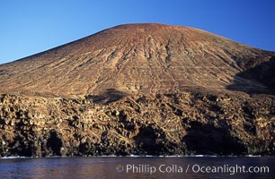 Red Cinder Cone and erodes sea cliffs overlook a fur seal colony and excellent dive site, west side of Guadalupe Island (Isla Guadalupe), Mexico.  Goat trails can be seen near the base of the cinder cone