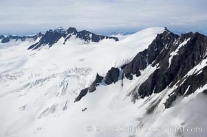 The Kenai Mountains rise above thick ice sheets and the Harding Icefield which is one of the largest icefields in Alaska and gives rise to over 30 glaciers, Kenai Fjords National Park