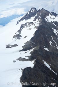 The Kenai Mountains rise above thick ice sheets and the Harding Icefield which is one of the largest icefields in Alaska and gives rise to over 30 glaciers, Kenai Fjords National Park