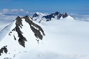 The Kenai Mountains rise above thick ice sheets and the Harding Icefield which is one of the largest icefields in Alaska and gives rise to over 30 glaciers, Kenai Fjords National Park