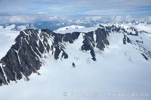 The Kenai Mountains rise above thick ice sheets and the Harding Icefield which is one of the largest icefields in Alaska and gives rise to over 30 glaciers, Kenai Fjords National Park