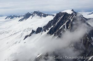 The Kenai Mountains rise above thick ice sheets and the Harding Icefield which is one of the largest icefields in Alaska and gives rise to over 30 glaciers, Kenai Fjords National Park