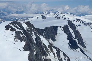 The Kenai Mountains rise above thick ice sheets and the Harding Icefield which is one of the largest icefields in Alaska and gives rise to over 30 glaciers, Kenai Fjords National Park