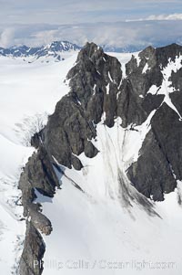 The Kenai Mountains rise above thick ice sheets and the Harding Icefield which is one of the largest icefields in Alaska and gives rise to over 30 glaciers, Kenai Fjords National Park