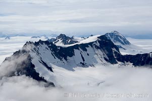 The Kenai Mountains rise above thick ice sheets and the Harding Icefield which is one of the largest icefields in Alaska and gives rise to over 30 glaciers, Kenai Fjords National Park